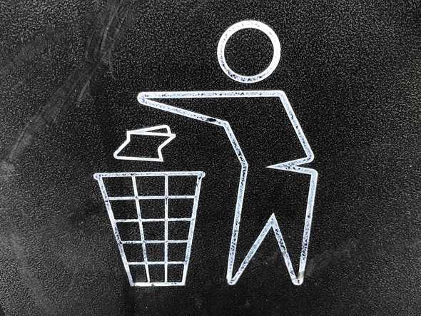 Sign showing man throwing away trash, photo by Gary Chan