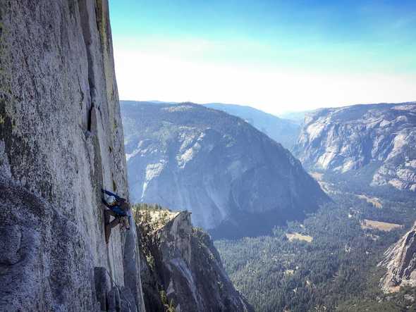 Photo of man climbing a mountain in Yosemite by Billy Onjea