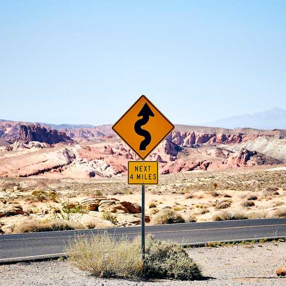 Photo of Lonely Winding Road Sign by Fabien Bazanegue